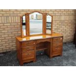 A kneehole dressing table with triptych