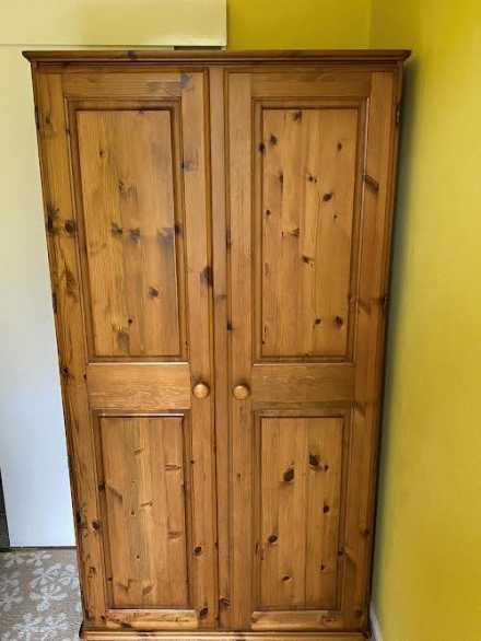 A pine twin door wardrobe measuring appr