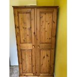 A pine twin door wardrobe measuring appr