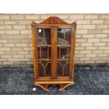 A glazed wall hanging corner cabinet, ap