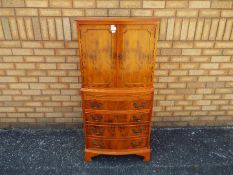 A tallboy cupboard over chest with twin