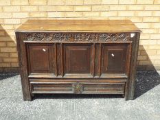 An antique carved oak mule chest with single drawer, carved decoration,