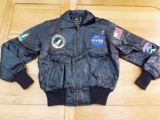 NASA - a black leather zip front jacket with five patch badges by Alpha Industries,