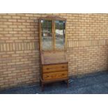 An oak bureau bookcase with astragal gla