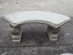 Garden Stoneware - A reconstituted stone bench with curved seat on two plinths.