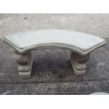 Garden Stoneware - A reconstituted stone bench with curved seat on two plinths.