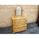 A pine chest of four drawers measuring a