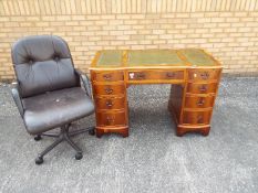 A kneehole desk and chair, desk approximately 78 cm x 117 cm x 58 cm.