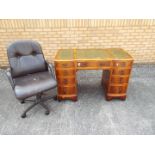 A kneehole desk and chair, desk approximately 78 cm x 117 cm x 58 cm.
