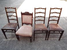 Three ladder back chairs and one other.