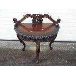 A demi lune console table with carved decoration on tripod supports,