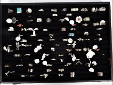 A collection of white metal rings contai