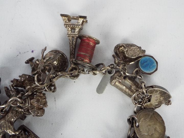 A silver charm bracelet with various silver and white metal charms, padlock clasp and safety chain, - Image 3 of 4