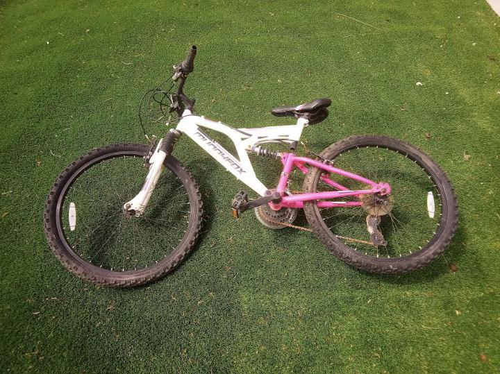 Mountain Bike - a white and hot pink Muddy Fox Recoil 24 mountain bike with 24" wheels,