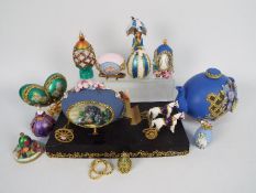 A quantity of decorative egg ornaments, some stone set, some with stands.