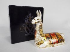 Royal Crown Derby - A boxed Collectors Guild exclusive paperweight, Llama, with gold stopper.
