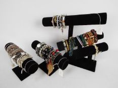 Three bracelet display stands with various bracelets,