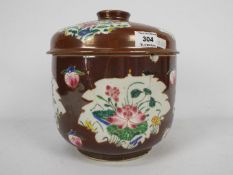 A Chinese 'Batavia' ware bowl and cover decorated with floral panels and peaches,