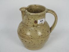 Phil Rogers - A studio pottery stoneware jug with speckled decoration, approximately 19 cm (h),