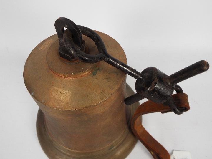 A large cast brass and iron bell, approximately 21 cm (h) and two decorative lustre jugs. - Image 3 of 4