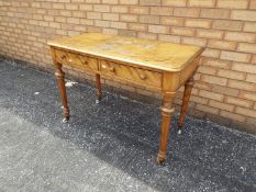 A Victorian mahogany hall table on tapered supports terminating in castors,