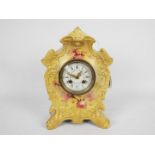 A ceramic cased mantel clock with floral decoration, approximately 30 cm (h).