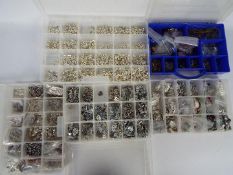 A quantity of jewellery crafting items, white metal charms / pendants contained in five cases.