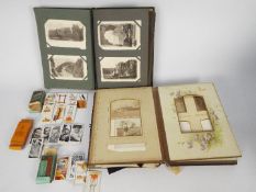An antique photograph album containing various photographs, cartes de visite and similar,