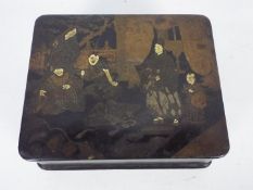 An Oriental lacquered box with hinged lid,