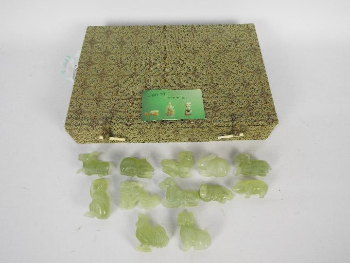 A set of Chinese zodiac jade carvings contained in presentation box.