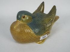 A Lladro figurine in the form of a Mandarin Duck, approximately 24 cm (l).