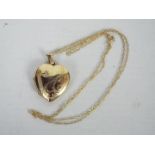 A 9ct gold heart shape, stone set locket on chain stamped 9k, 3.3 grams all in.