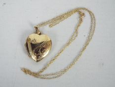 A 9ct gold heart shape, stone set locket on chain stamped 9k, 3.3 grams all in.