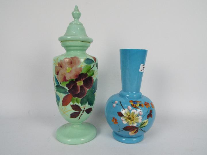 Two glass vases with hand painted floral decoration, largest approximately 27 cm (h).