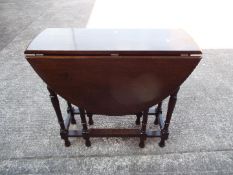 A drop leaf table measuring approximately 77 cm x 81 cm x 116 cm (when extended)