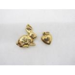 Two 9ct gold charms comprising one in the form of a heart and one in the form of a rabbit.
