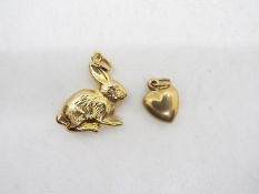 Two 9ct gold charms comprising one in the form of a heart and one in the form of a rabbit.