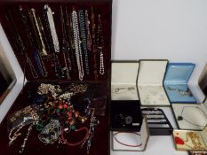 A table top / portable jewellery display containing a quantity of various necklaces and a further