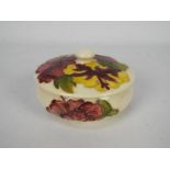 Moorcroft - A Moorcroft Pottery hibiscus pattern, cream ground, powder bowl and cover,