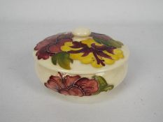 Moorcroft - A Moorcroft Pottery hibiscus pattern, cream ground, powder bowl and cover,