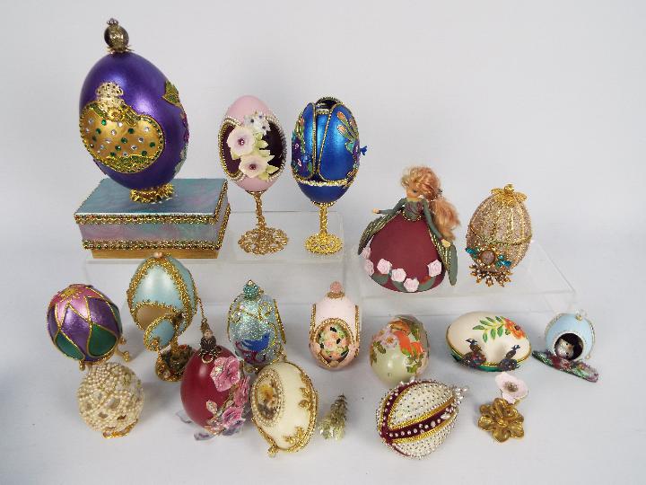 A quantity of decorative egg ornaments, some with stands.