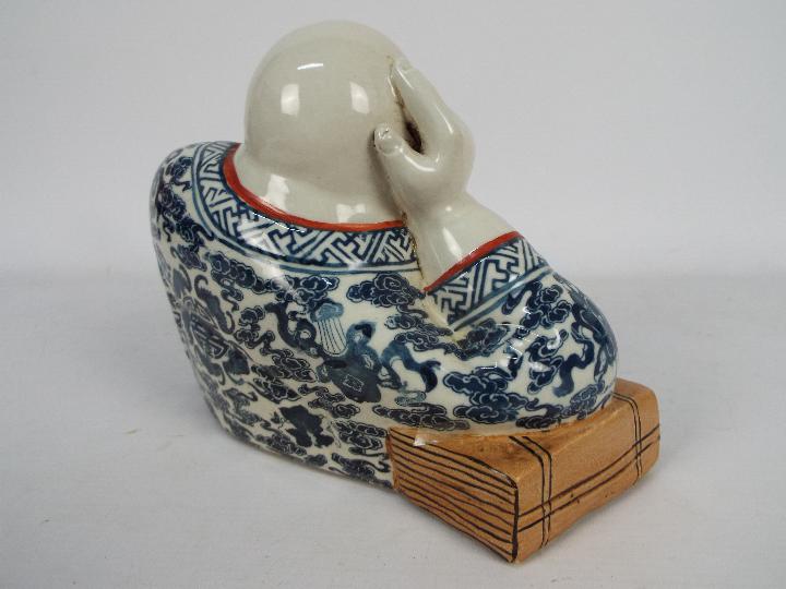 A Chinese ceramic model depicting Budai in reclining pose clutching a string of gilt beads, - Image 6 of 7