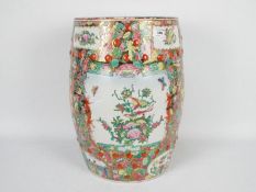 A Chinese famille rose garden seat of barrel or drum form, decorated with pierced cash motifs,