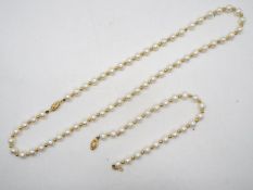 A yellow metal and pearl necklace and bracelet set, the clasp of each stamped 585 for 14ct,