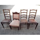 Three ladder back chairs and one other.