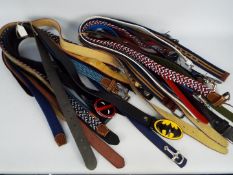 A job lot of 24 leather belts, all different,