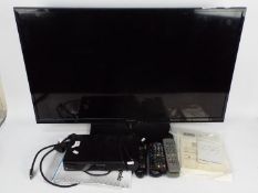 A 39" LED Panasonic television model TX-L39EM6B and a Freeview box.