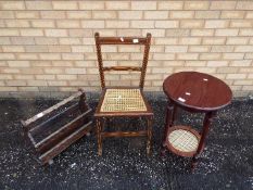 A hall chair with cane seat, an occasional table measuring 63 cm x 40 cm and a magazine rack.