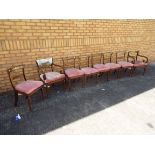 A matched set of 6 dining chairs and two carvers, upholstered pink seats.