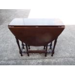 A drop leaf table measuring approximately 77 cm x 81 cm x 116 cm (when extended)